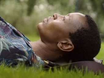 Billie Zangewa lying on the grass